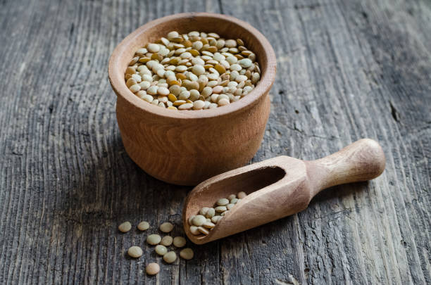 istock Brown dried lentils in a wooden bowl 995117184