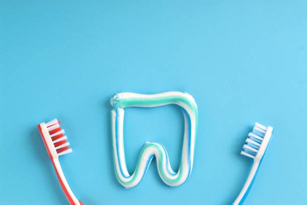 istock Red and blue toothbrushes and colorful toothpaste shapes 995119866