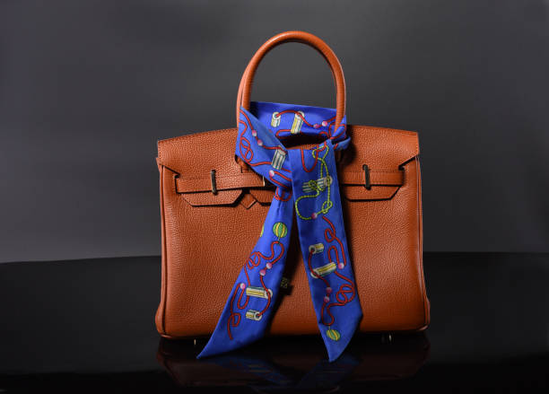 istock The orange lady's backpack is tied with a silk scarf and worn on the handle. 995132406