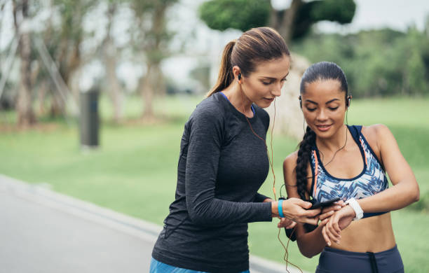 istock Runner girls are resting and watching a smart watch after run 995132894