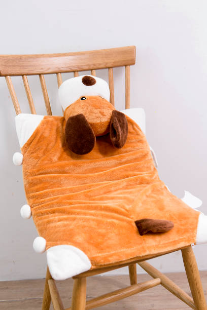 istock Yellow plush puppy pillows on a chair 995133432