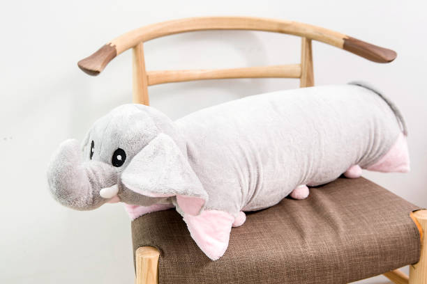 istock Gray plush elephant pillow on a chair 995133506