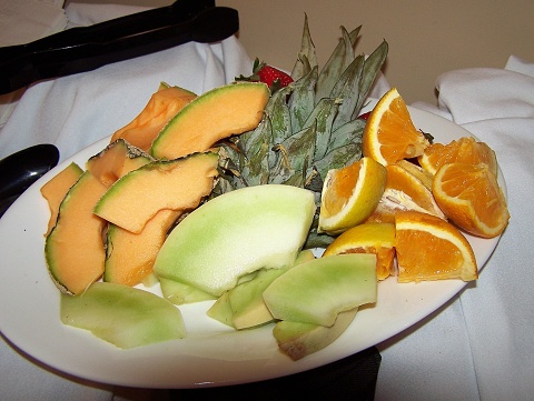 Pineapple, green melons, canaloupe and oranges.