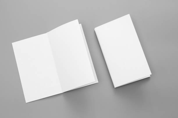 istock Blank portrait A4. brochure magazine isolated on gray, changeable background / white paper business card isolated on gray 995155914