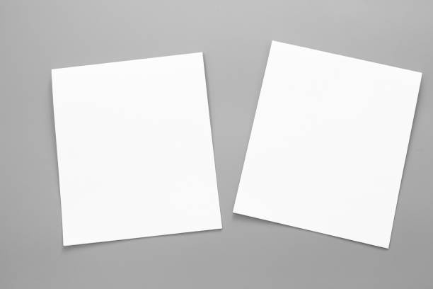 istock Blank portrait A4. brochure magazine isolated on gray, changeable background / white paper business card isolated on gray 995158010