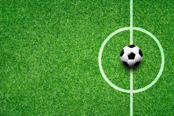 istock soccer field center and ball top view background 995205972