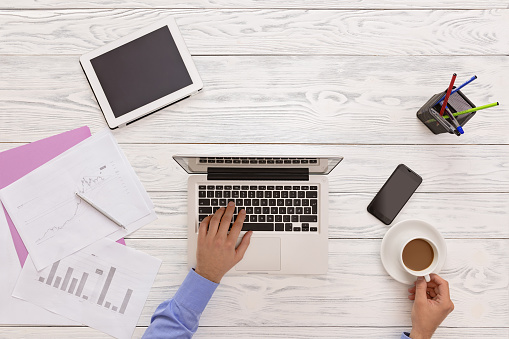 Top View Of A Man Working At The Office And Drinking Coffee