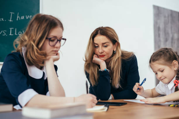 istock Pupils and female caucasian teacher in classroom 995239218