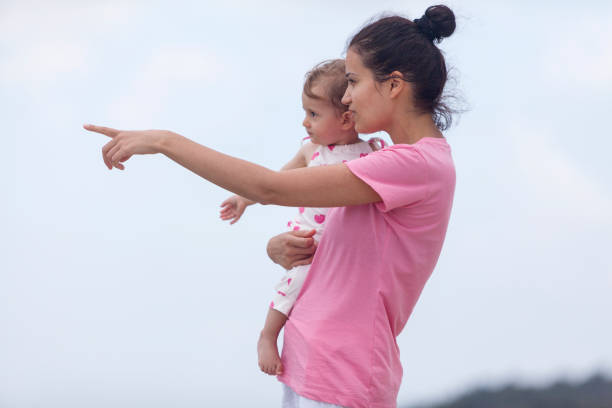 istock mother and daughter having fun at the beach 995255444