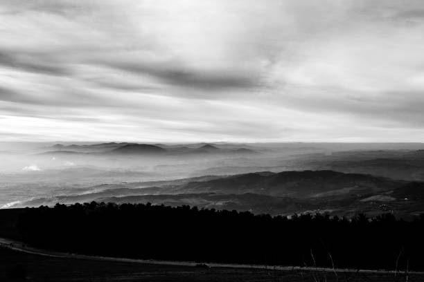istock Subasio Mt. (Umbria, Italy), with sky covered by clouds and mist on the valley underneath 995258474