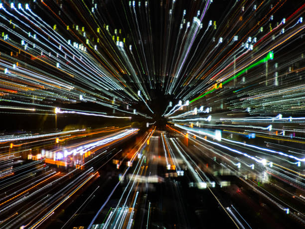 istock light lines with long exposure,  speed motion abstract background in the dark night ,  blast zoom effect , zoom burst of light in the city 995276644
