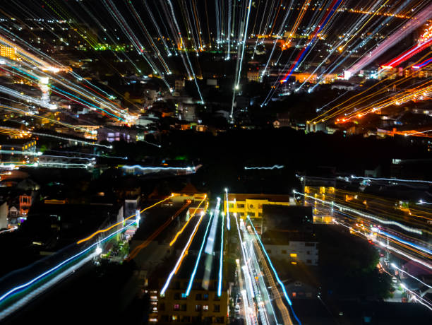 istock light lines with long exposure,  speed motion abstract background in the dark night ,  blast zoom effect , zoom burst of light in the city 995276650