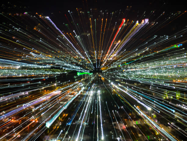 istock light lines with long exposure,  speed motion abstract background in the dark night ,  blast zoom effect , zoom burst of light in the city 995276656