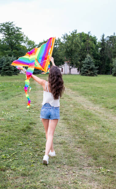 istock Lets go fly a kite, girl flying their kite. 995285320