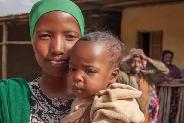 Muslim woman poses with her baby in Harar, Ethiopia. stock photo