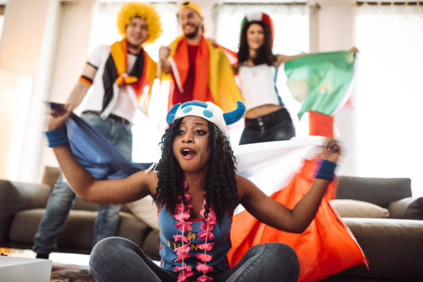 istock supporter cheering with beer in front of the TV 995291854