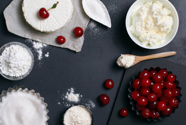 istock Dairy Products, Flour, Sugar and Cherries on Black Background 995291982