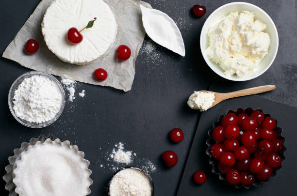 istock Dairy Products, Flour, Sugar and Cherries on Black Background 995292048
