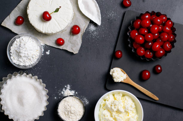 istock Dairy Products, Flour, Sugar and Cherries on Black Background 995292584