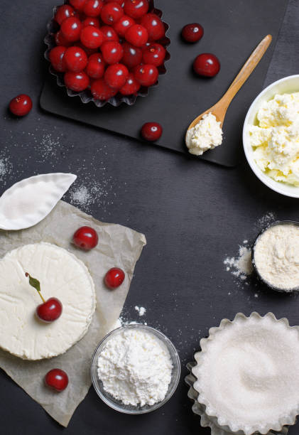 istock Dairy Products, Flour, Sugar and Cherries on Black Background 995292626
