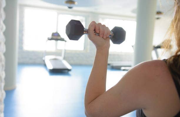 istock Woman workout with dumbbells at the gym 995296216