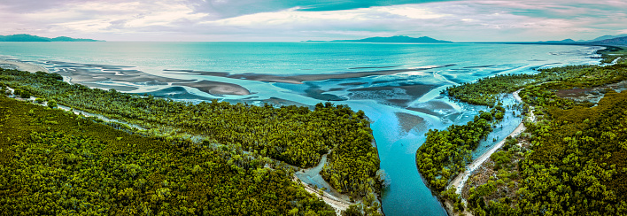 Aerial view during the sunrise over a river surrounded by mangroves