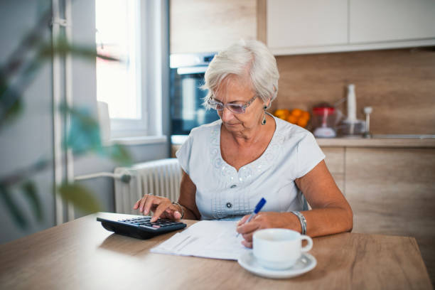 istock Stressed senior woman is doing banking and administrative work at home 995298650
