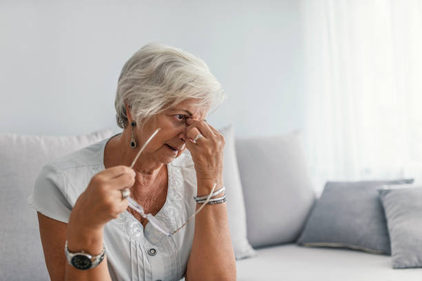 istock Woman suffering from stress or a headache grimacing in pain, with copyspace 995301938