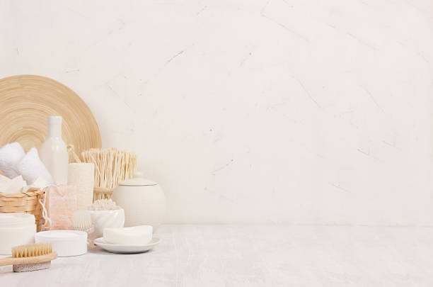 istock Natural spa white cosmetics products and beige bamboo rustic decor on white wood background, interior, border. 995302526