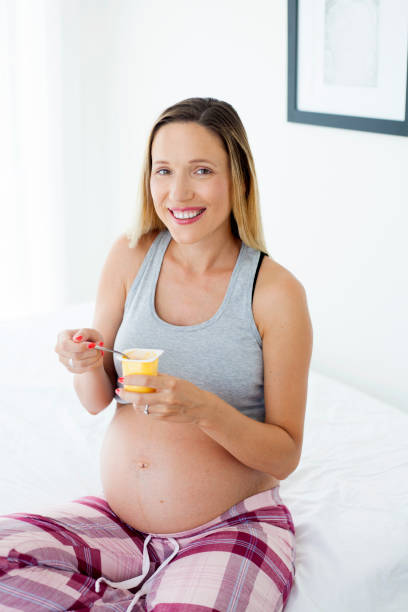 istock Pregnant woman eating yogurt 995308798