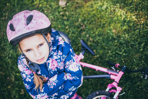 istock Young Grimacing Girl With a Bicycle 995309864