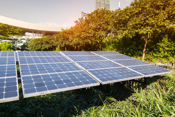 istock Ecological energy renewable solar panel plant with urban landscape landmarks 995309960