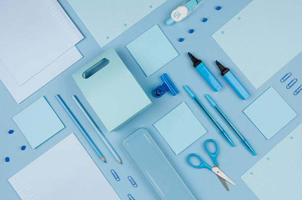 istock Modern youth workplace - neon blue stationery as decorative pattern on blue background, top view. 995312292