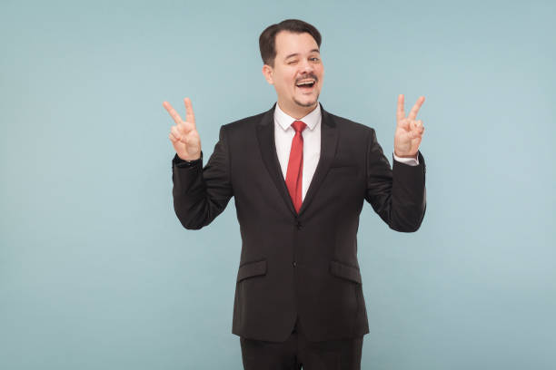istock Businessman showing finger nomber four and wink 995312920