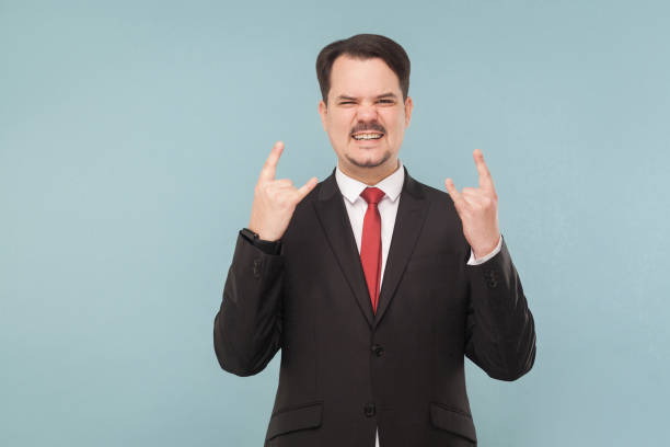 istock Businessman showing rock and roll sign 995312922