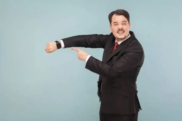 Photo of Business man showing at smart watch