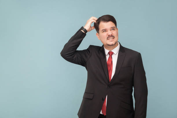 istock Thinking well dressed man, looking up and pondering 995312956
