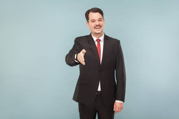 istock Boss showing handshake, toothy smiling 995313002