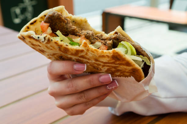 istock pita burger fast food in hand 995316016
