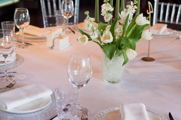 istock Classic table setting. White tablecloth. Vase with hydrogel and white flowers.The table of young. Specific 995319650