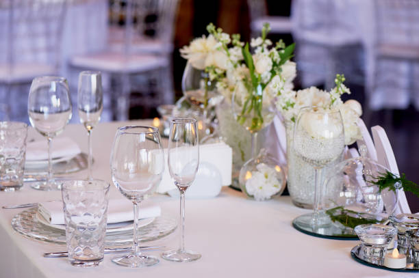istock Classic table setting. White tablecloth. Vase with hydrogel and white flowers.The table of young. Specific 995319684
