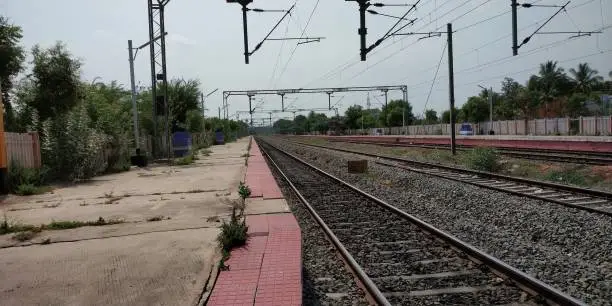 A deserted look of railway station platform and and railway track.