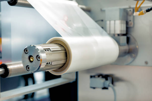 istock Roll of packaging film. Feeding unit of a modern packaging machine 995323046