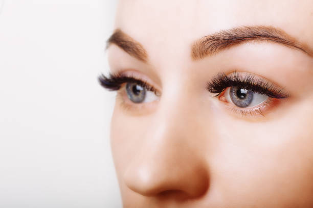 istock Eyelash Extension Procedure. Woman Eye with Long Eyelashes. Close up, selective focus 995323172
