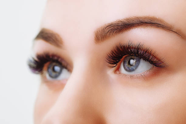 istock Eyelash Extension Procedure. Woman Eye with Long Eyelashes. Close up, selective focus 995323186