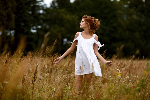 istock beautiful girl in field 995326338