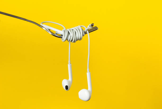 istock Fork and headphones on a yellow background, close-up 995329390
