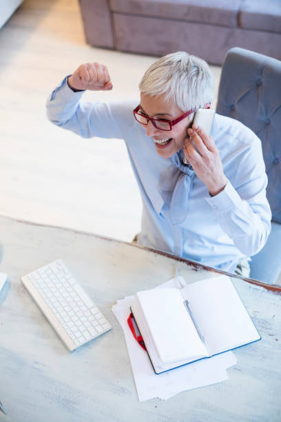 istock Beautiful gray hair elderly woman next to computer 995335660
