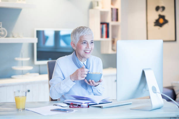 istock Beautiful gray hair elderly woman next to computer 995336094