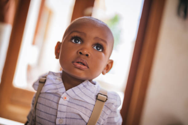 Portrait of cute little baby boy at home Portrait of adorable little African-American boy with big black eyes at home large eyes stock pictures, royalty-free photos & images